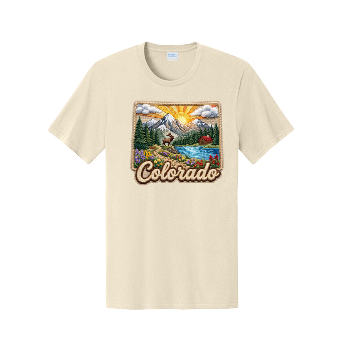 A cream-colored short-sleeve t-shirt with a colorful graphic print of a Colorado landscape featuring mountains, a lake, and the word 'Colorado' in retro lettering.